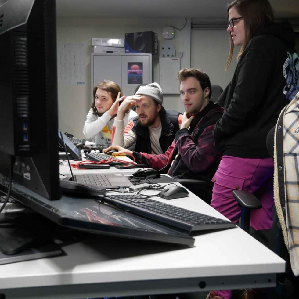 MetStudios Brighton postgrad students working at a computer together