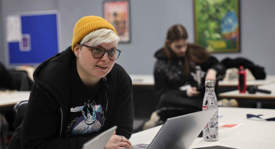 MetStudios student with hat at a table
