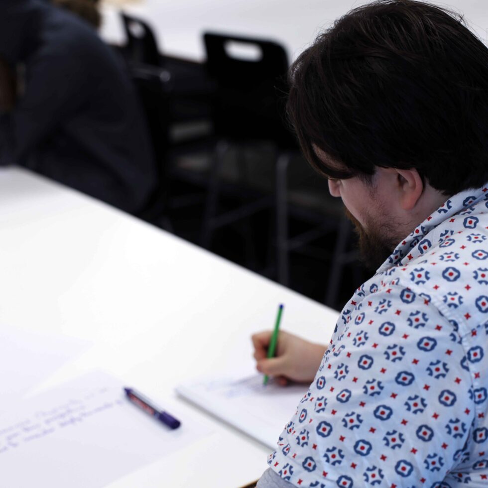 MetStudios student writing on paper